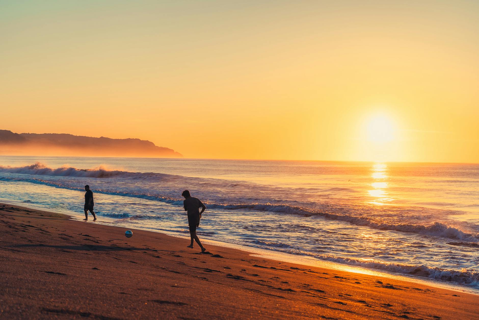 people on the beach at sunset