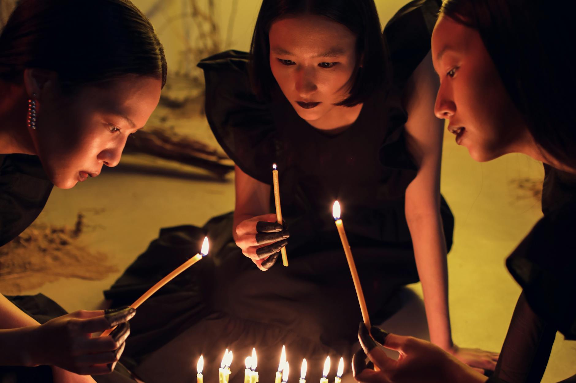 women holding lighted candles