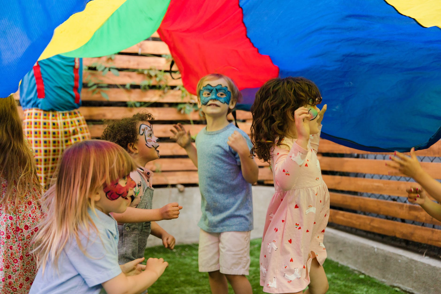 a group of kids with face paint during a party