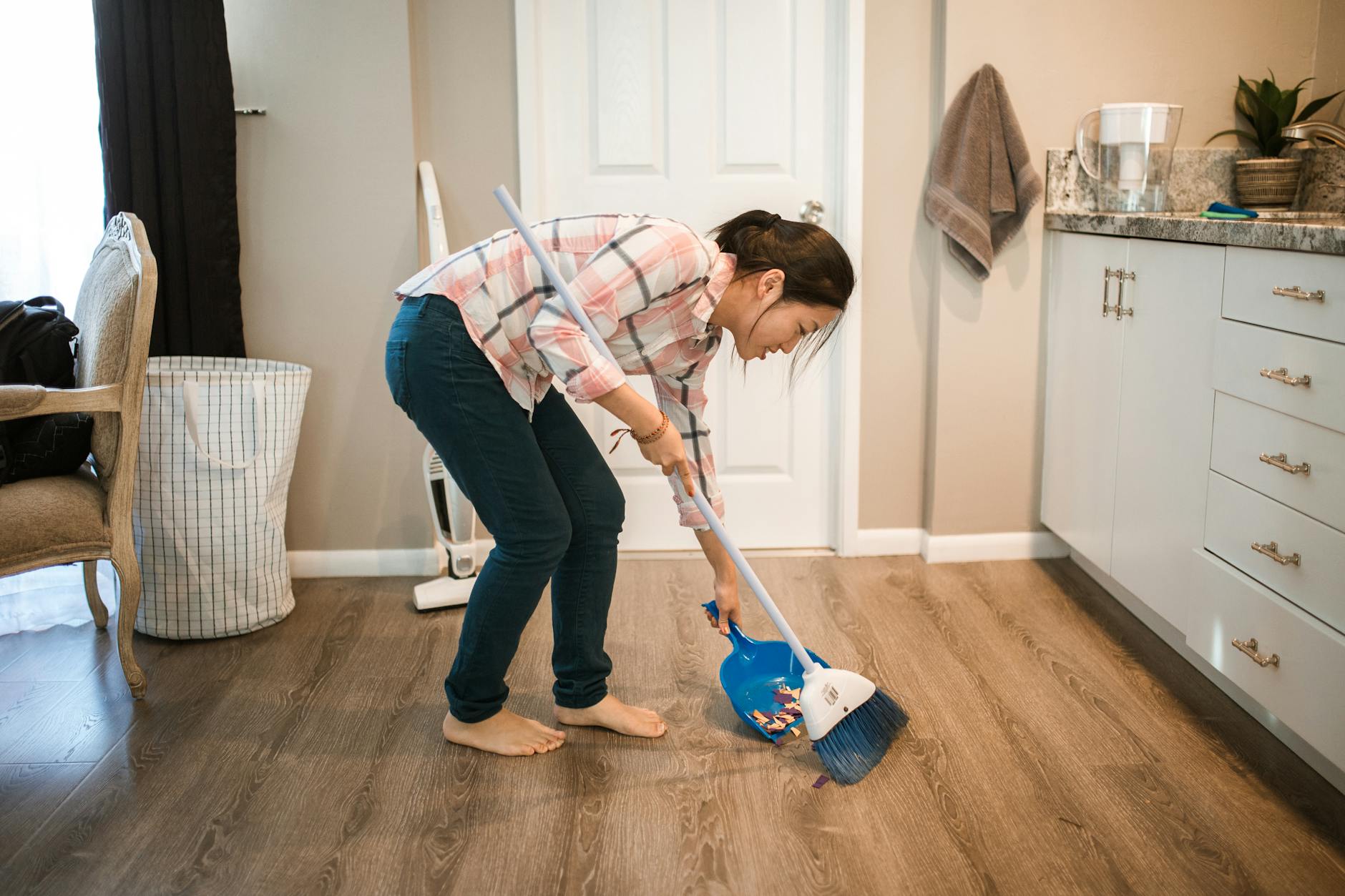 a woman sweeping the floor