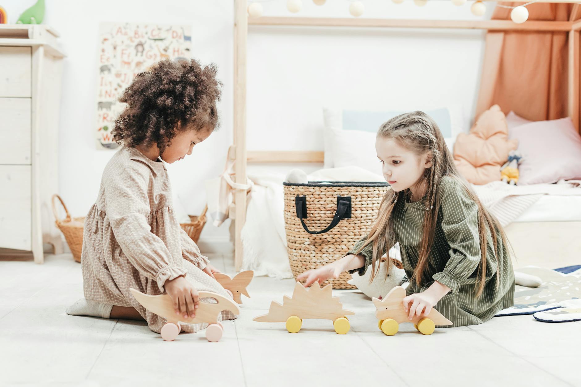 photo of girls playing with wooden toys